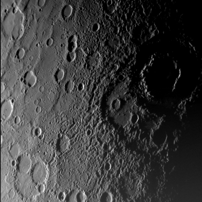 As NASA's MESSENGER spacecraft approached Mercury on January 14, 2008, it captured this view of the planet's rugged, cratered landscape illuminated obliquely by the sun. This image was taken from a distance of approximately 11,000 miles, about 56 minutes before the spacecraft's closest encounter with Mercury. It shows a region 300 miles across including craters less than a mile wide. The large, shadow-filled, double ringed crater to the upper right was glimpsed by Mariner 10 more than three decades ago and named Vivaldi, after the Italian composer. Credit: NASA/Johns Hopkins University Applied Physics Laboratory/Carnegie Institution of Washington.