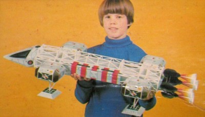 A 70s child holding an Eagle toy from Space:1999